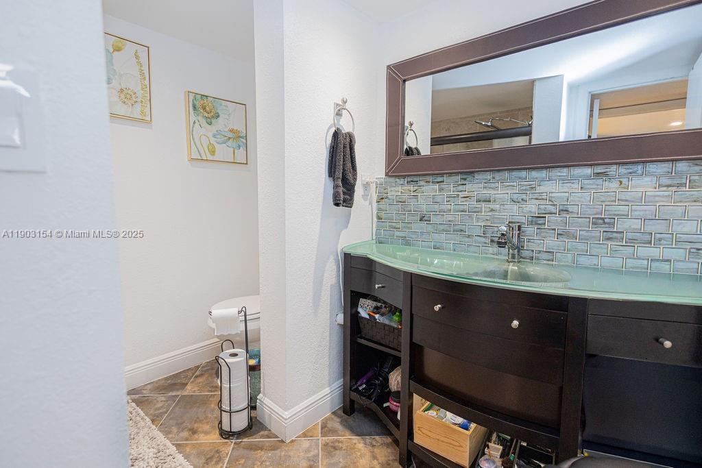 3450 Blue Lake Drive, Unit 305 Pompano Beach, FL 33064 - Photo 56 of 66 a room with a sink and a mirror