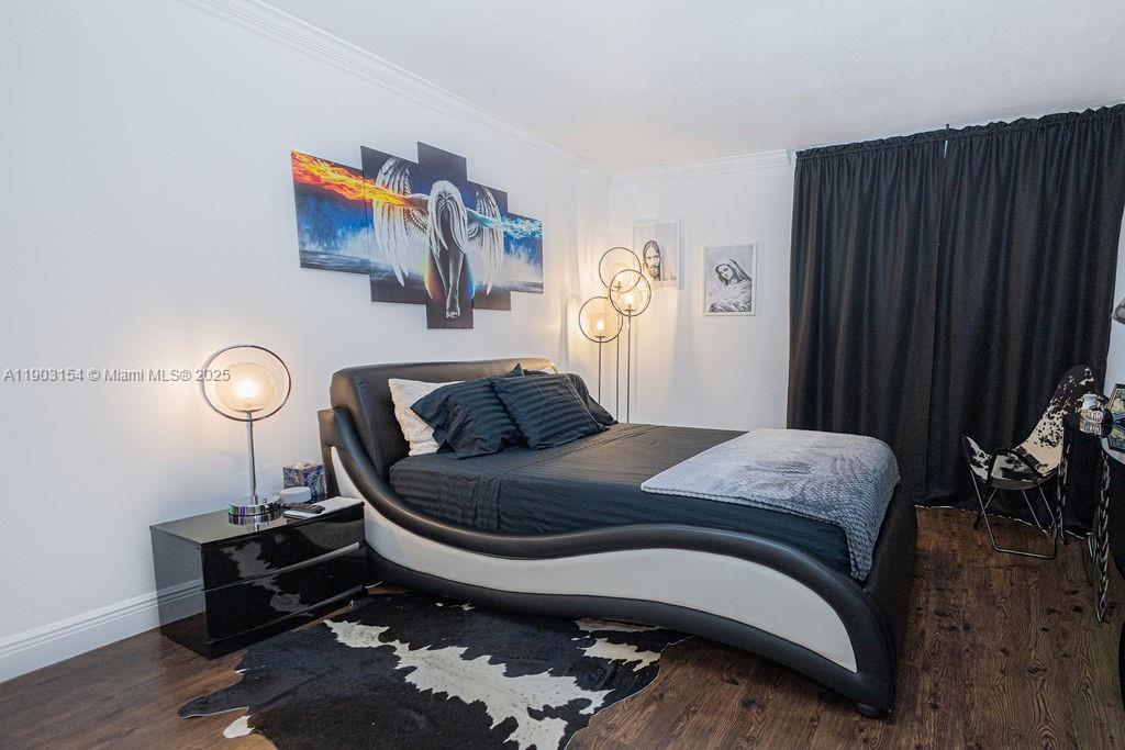 3450 Blue Lake Drive, Unit 305 Pompano Beach, FL 33064 - Photo 60 of 66 a bedroom with a bed and painting on the wall