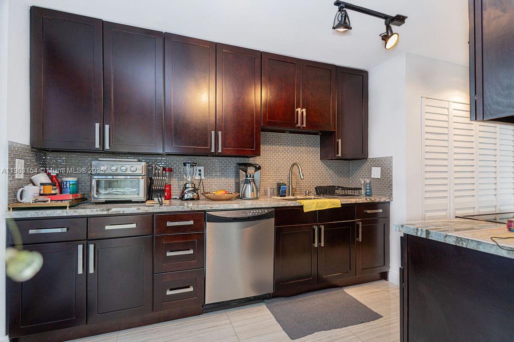 3450 Blue Lake Drive, Unit 305 Pompano Beach, FL 33064 - Photo 8 of 66 a kitchen with a sink a stove and cabinets