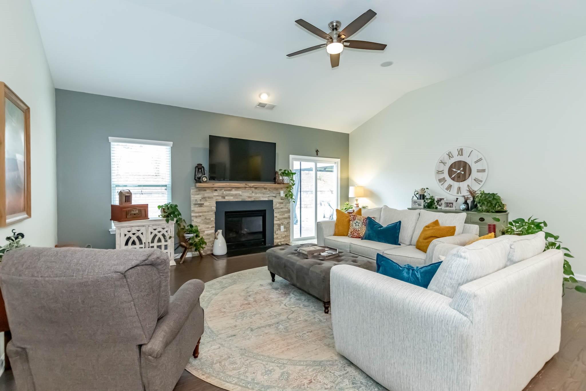 2984 Hiddenbrook Way Indian Land, SC 29707 - Photo 15 of 32 a living room with furniture a fireplace and a flat screen tv