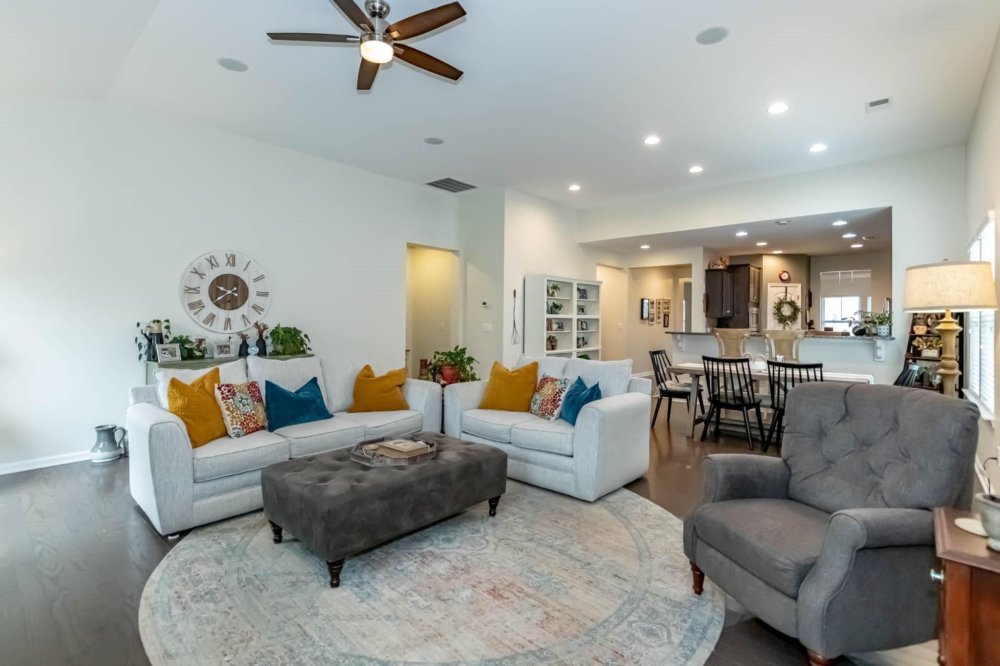 2984 Hiddenbrook Way Indian Land, SC 29707 - Photo 16 of 32 a living room with furniture kitchen view and a chandelier