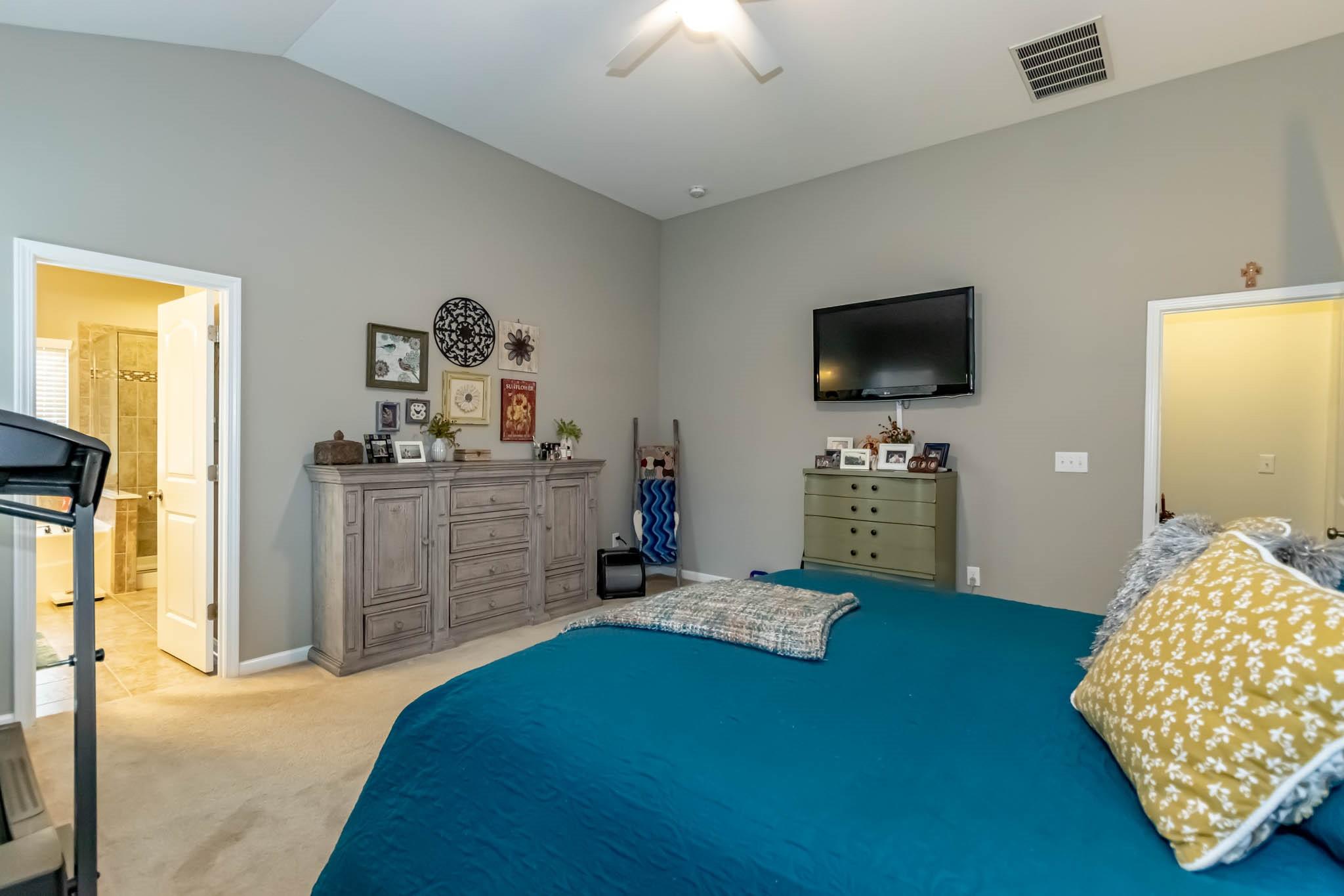 2984 Hiddenbrook Way Indian Land, SC 29707 - Photo 18 of 32 a bedroom with a bed and a flat screen tv