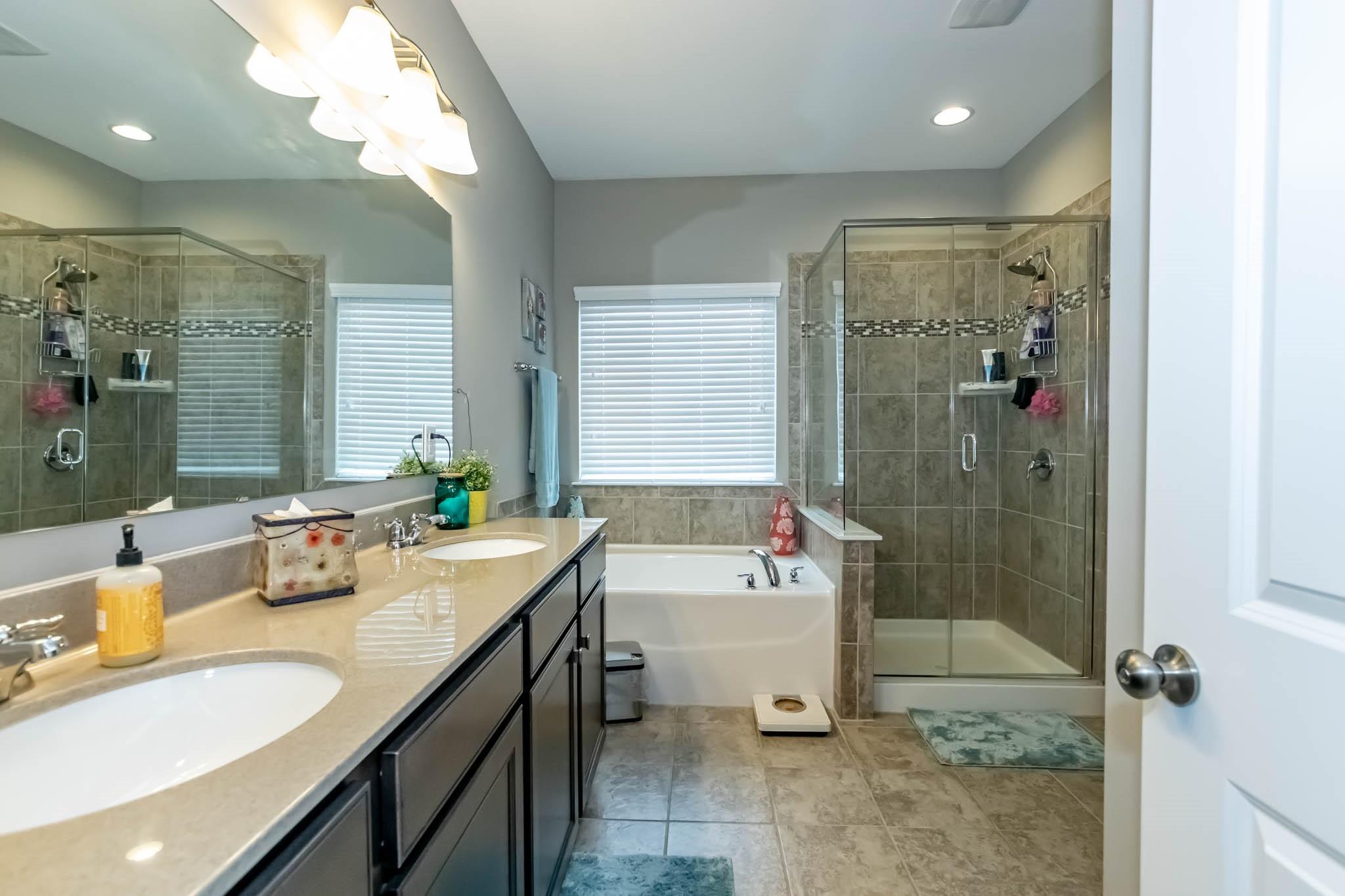 2984 Hiddenbrook Way Indian Land, SC 29707 - Photo 20 of 32 a bathroom with a granite countertop sink a toilet and shower