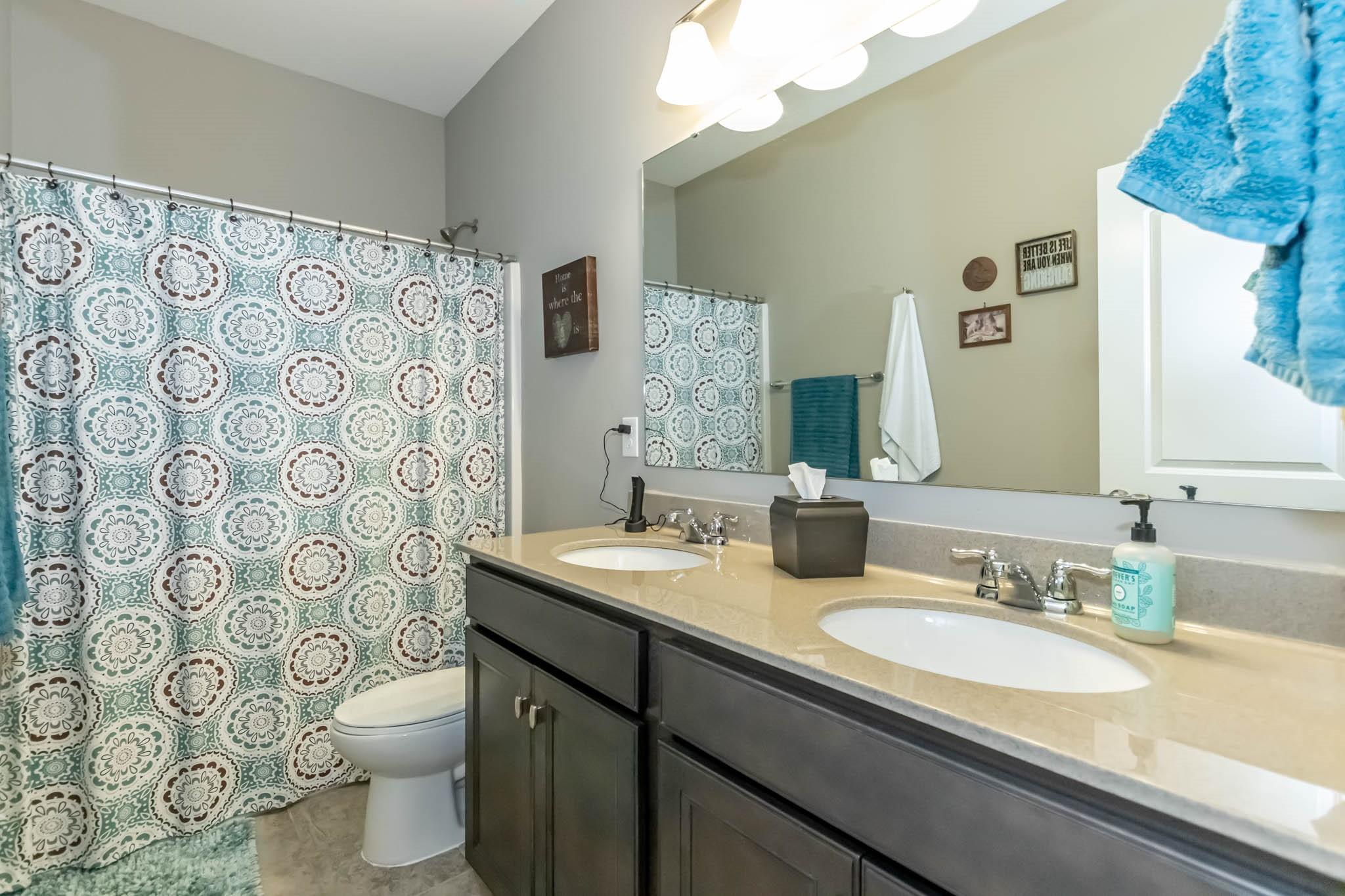 2984 Hiddenbrook Way Indian Land, SC 29707 - Photo 24 of 32 a bathroom with a granite countertop sink a toilet and a mirror