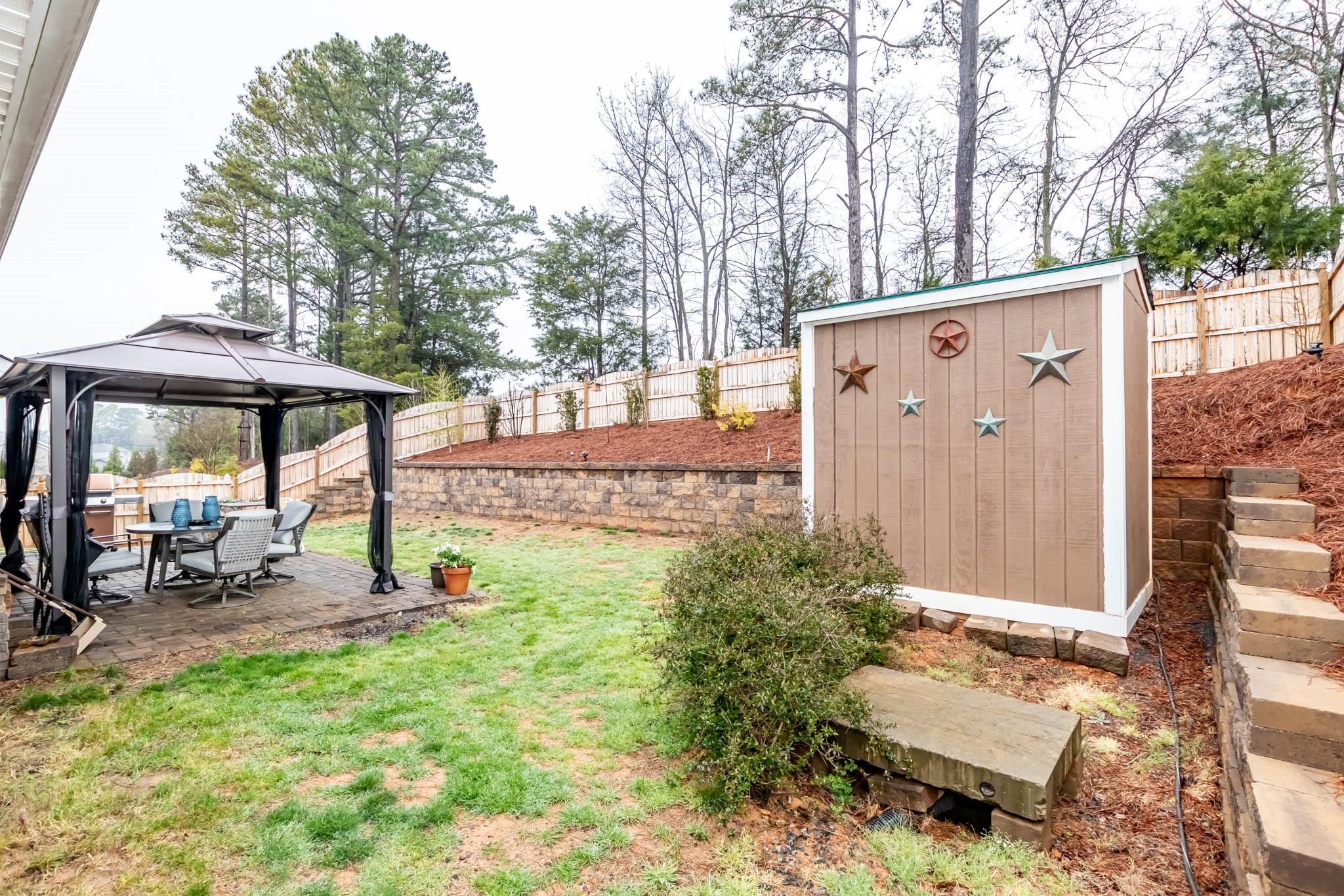 2984 Hiddenbrook Way Indian Land, SC 29707 - Photo 28 of 32 a backyard of a house with yard barbeque oven and outdoor seating