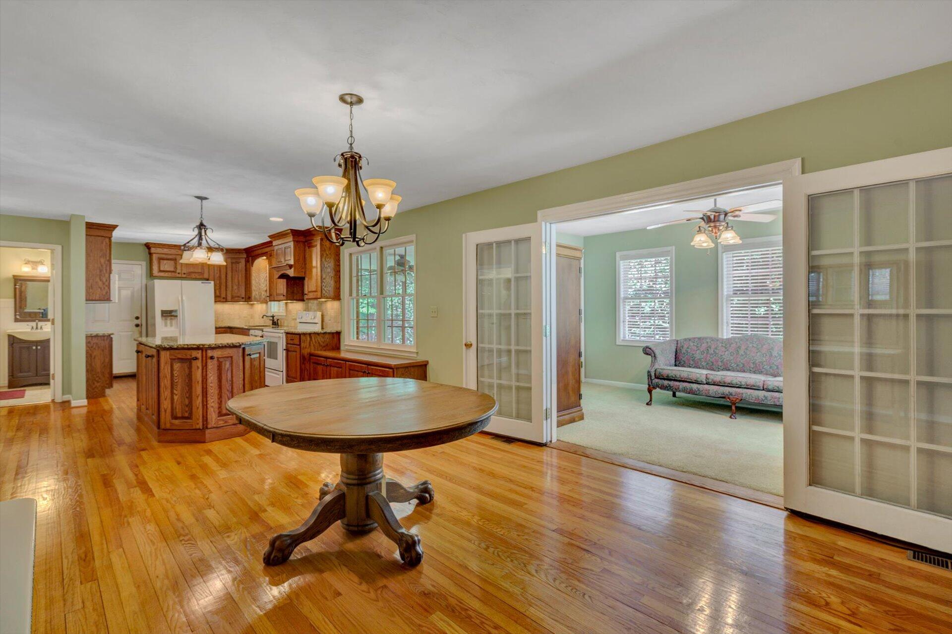43 Nottingham Lane Blue Ridge, VA 24064 - Photo 20 of 51 a dining room with wooden floor a chandelier a wooden table and chairs