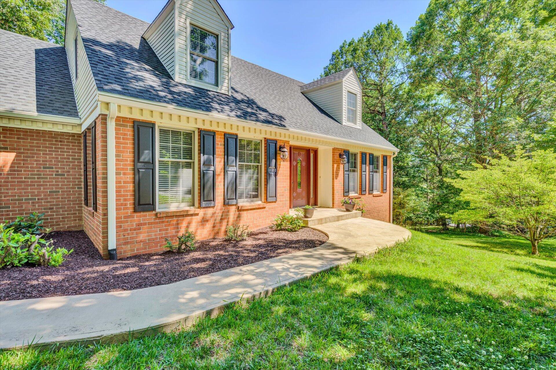 43 Nottingham Lane Blue Ridge, VA 24064 - Photo 6 of 51 a front view of a house with a yard outdoor seating and garage