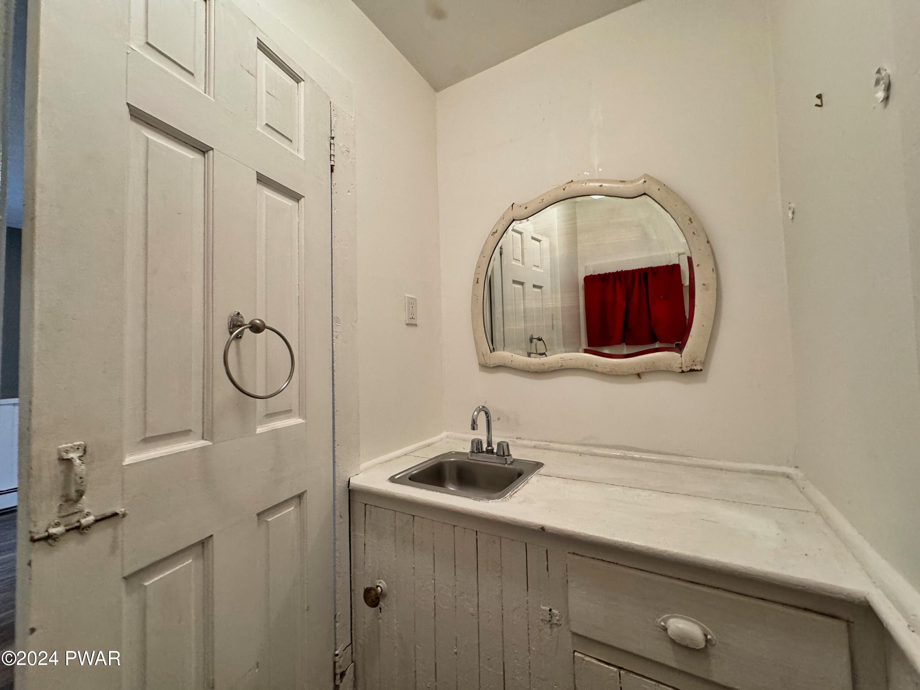 108 9th Street Milford, PA 18337 - Photo 15 of 38 a bathroom with a sink and a mirror