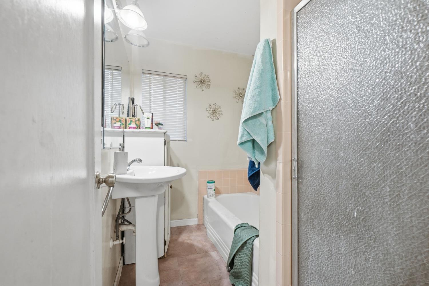 1705 Stetson Avenue Modesto, CA 95350 - Photo 14 of 32 a bathroom with a sink a mirror and toilet
