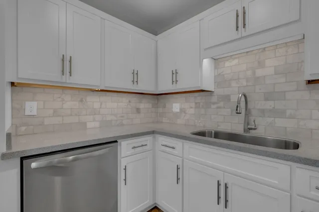 a view of a refrigerator in kitchen and wooden floor