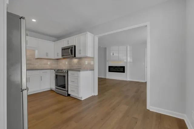a kitchen with stainless steel appliances granite countertop a refrigerator and a sink