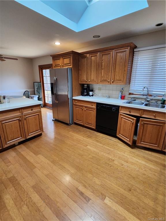 a large kitchen with stainless steel appliances granite countertop a sink counter space and cabinets