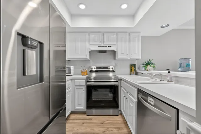 a kitchen with a sink stove and refrigerator