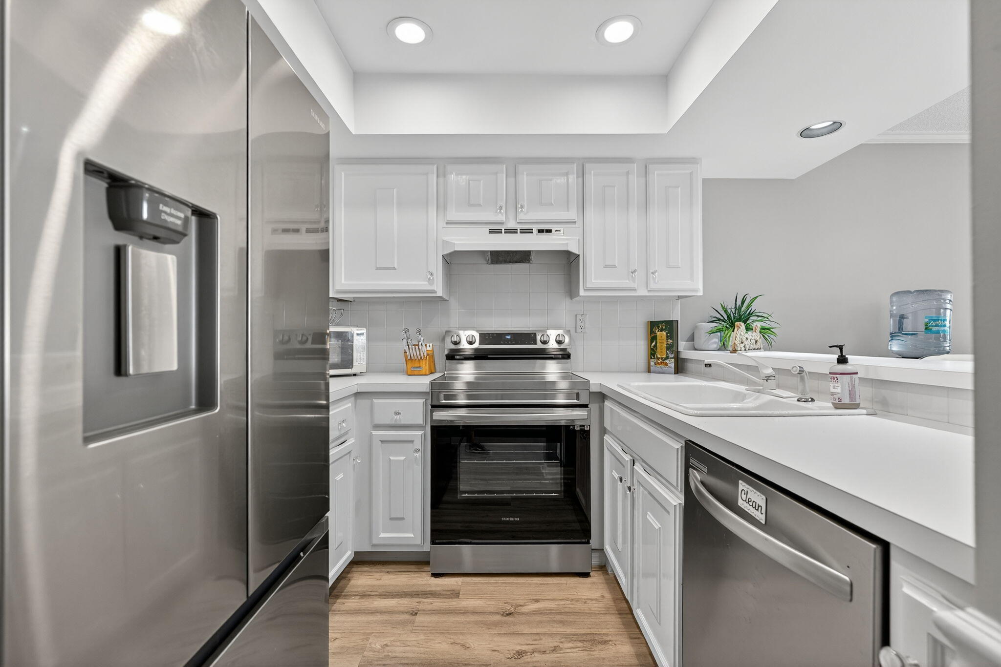 390 Northeast Edgewater Drive, Unit 403 Stuart, FL 34996 - Photo 11 of 46 a kitchen with a sink stove and refrigerator