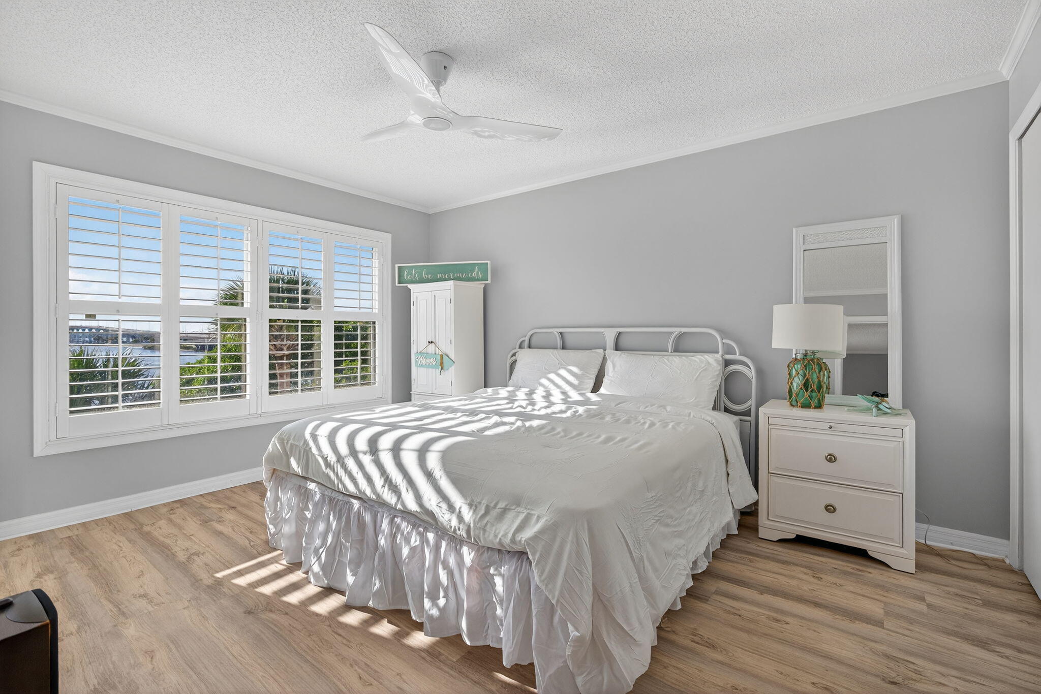 390 Northeast Edgewater Drive, Unit 403 Stuart, FL 34996 - Photo 14 of 46 a bedroom with a bed and a large window
