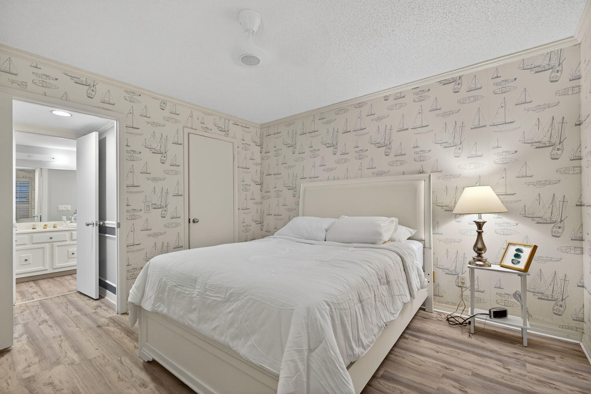 390 Northeast Edgewater Drive, Unit 403 Stuart, FL 34996 - Photo 19 of 46 a bedroom with a bed and a table