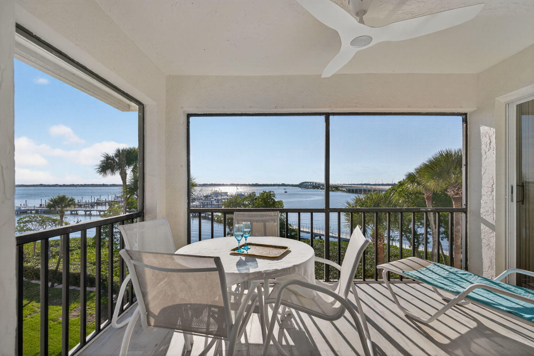 390 Northeast Edgewater Drive, Unit 403 Stuart, FL 34996 - Photo 2 of 46 a view of a balcony with table and chairs
