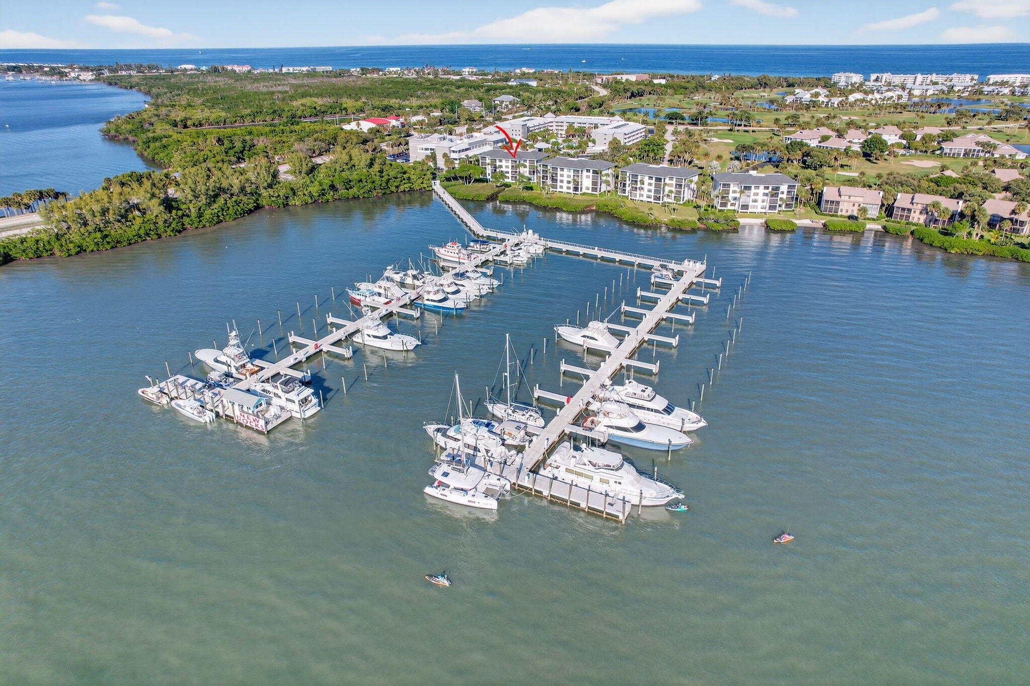 390 Northeast Edgewater Drive, Unit 403 Stuart, FL 34996 - Photo 26 of 46 an aerial view of a house with a table chairs and a floor to ceiling window