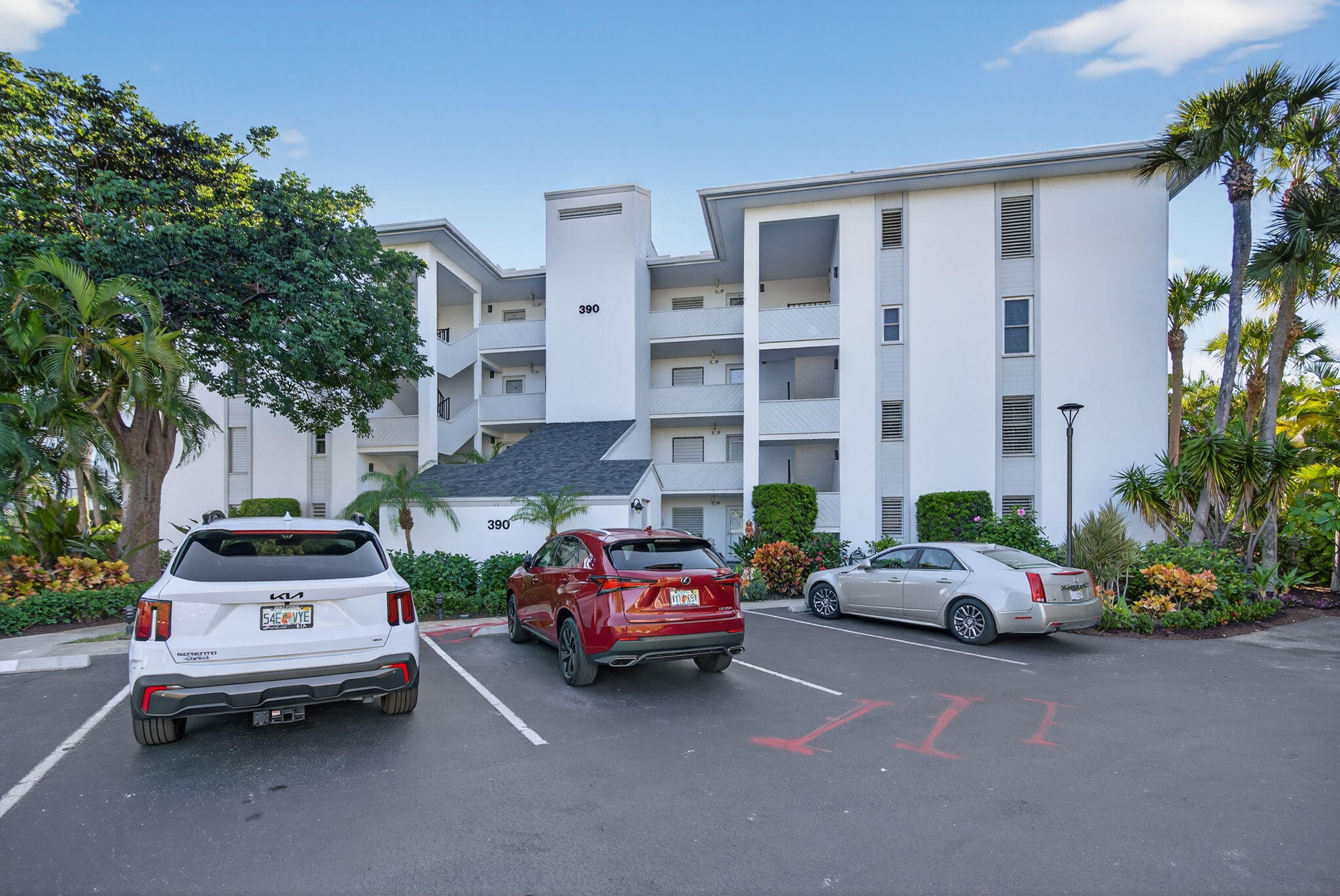 390 Northeast Edgewater Drive, Unit 403 Stuart, FL 34996 - Photo 40 of 46 a cars parked in front of a building