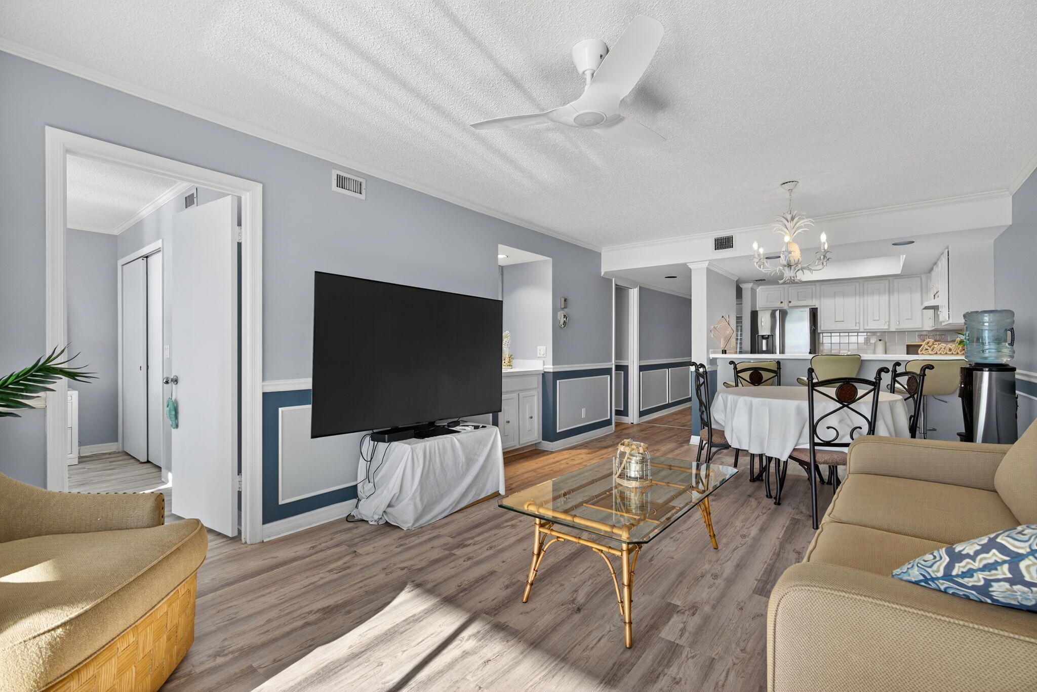 390 Northeast Edgewater Drive, Unit 403 Stuart, FL 34996 - Photo 7 of 46 a living room with lots of furniture and a flat screen tv