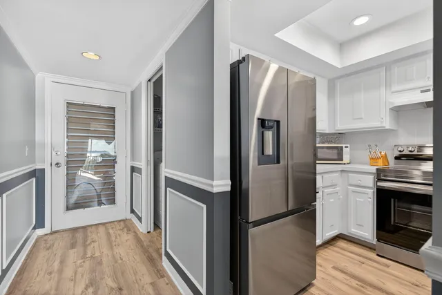 a kitchen with stainless steel appliances granite countertop a refrigerator and a stove top oven