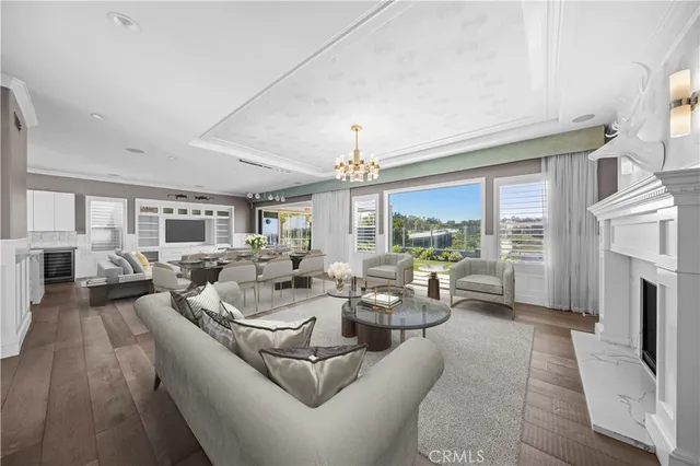 a living room with fireplace furniture and a chandelier