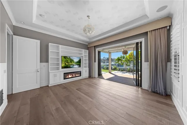 a view of a room with wooden floor and windows