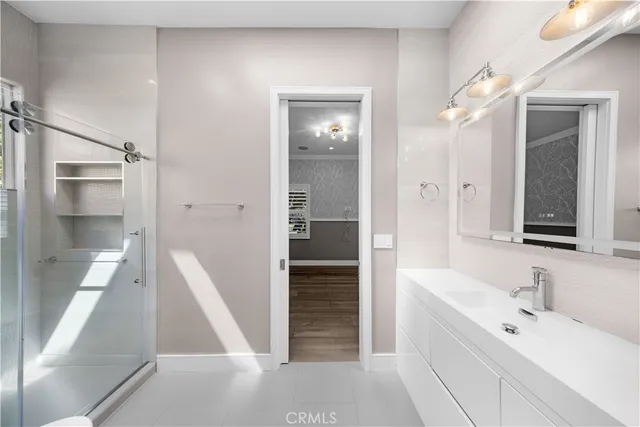a bathroom with a tub sink and mirror