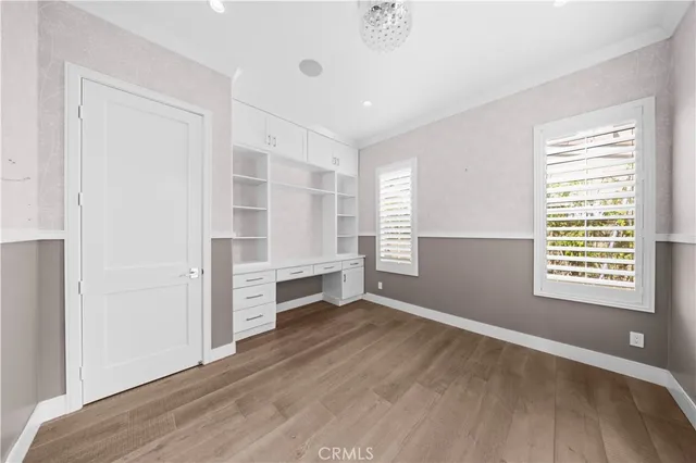 a view of an empty room with a window and fireplace