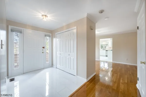 a view of empty room with wooden floor and fireplace