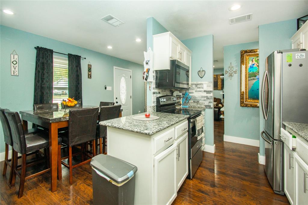 106 South 4th Street Celeste, TX 75423 - Photo 11 of 28 a kitchen with a table chairs refrigerator and furniture