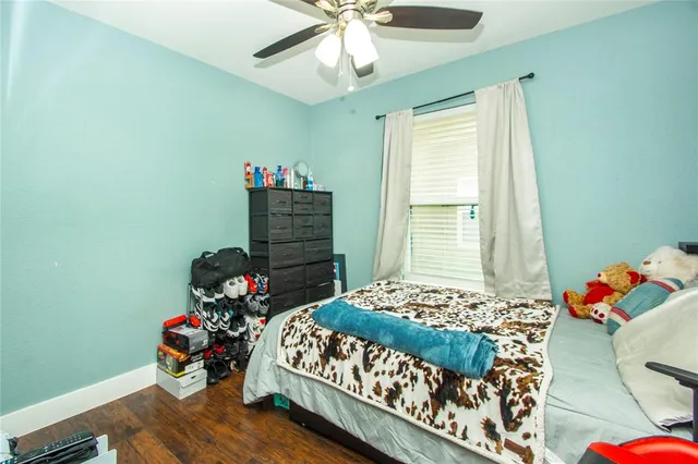 a bedroom with a bed and a dresser in it