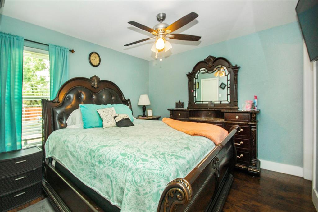 106 South 4th Street Celeste, TX 75423 - Photo 18 of 28 a bedroom with a bed and a large window with a chandelier