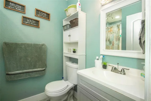 a bathroom with a sink a toilet and mirror