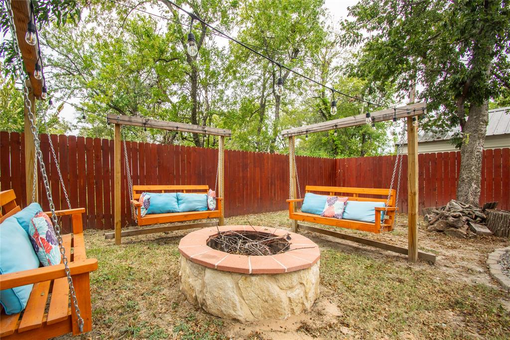 106 South 4th Street Celeste, TX 75423 - Photo 28 of 28 a view of a backyard with a small cabin and a chair