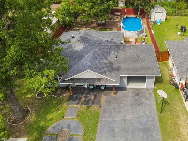 a aerial view of a house with swimming pool and porch