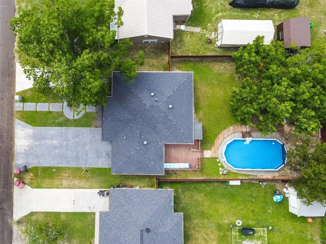 an aerial view of a house with yard swimming pool and outdoor seating
