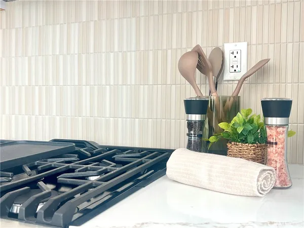 a kitchen with stainless steel appliances a stove a sink a microwave and cabinets