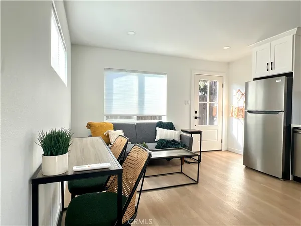 a kitchen with stainless steel appliances granite countertop a refrigerator a sink a stove a microwave and cabinets