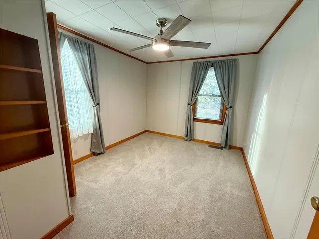 an empty room with windows and entryway