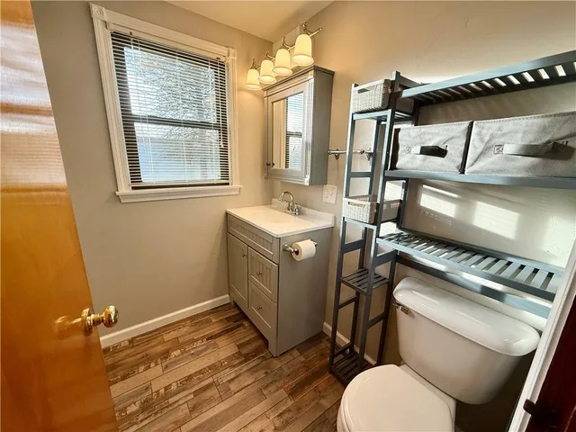 a bathroom with a sink mirror vanity and toilet