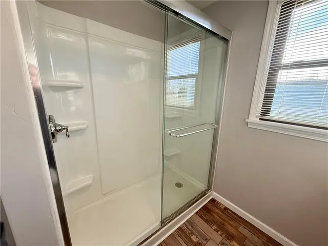 a bathroom with a glass shower door