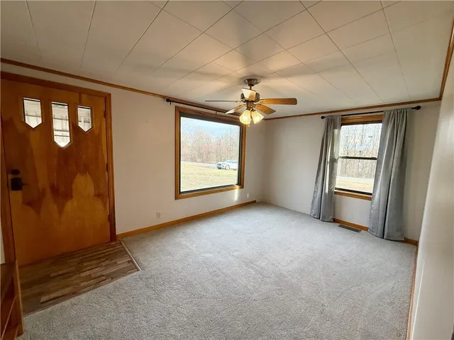 an empty room with windows and closet