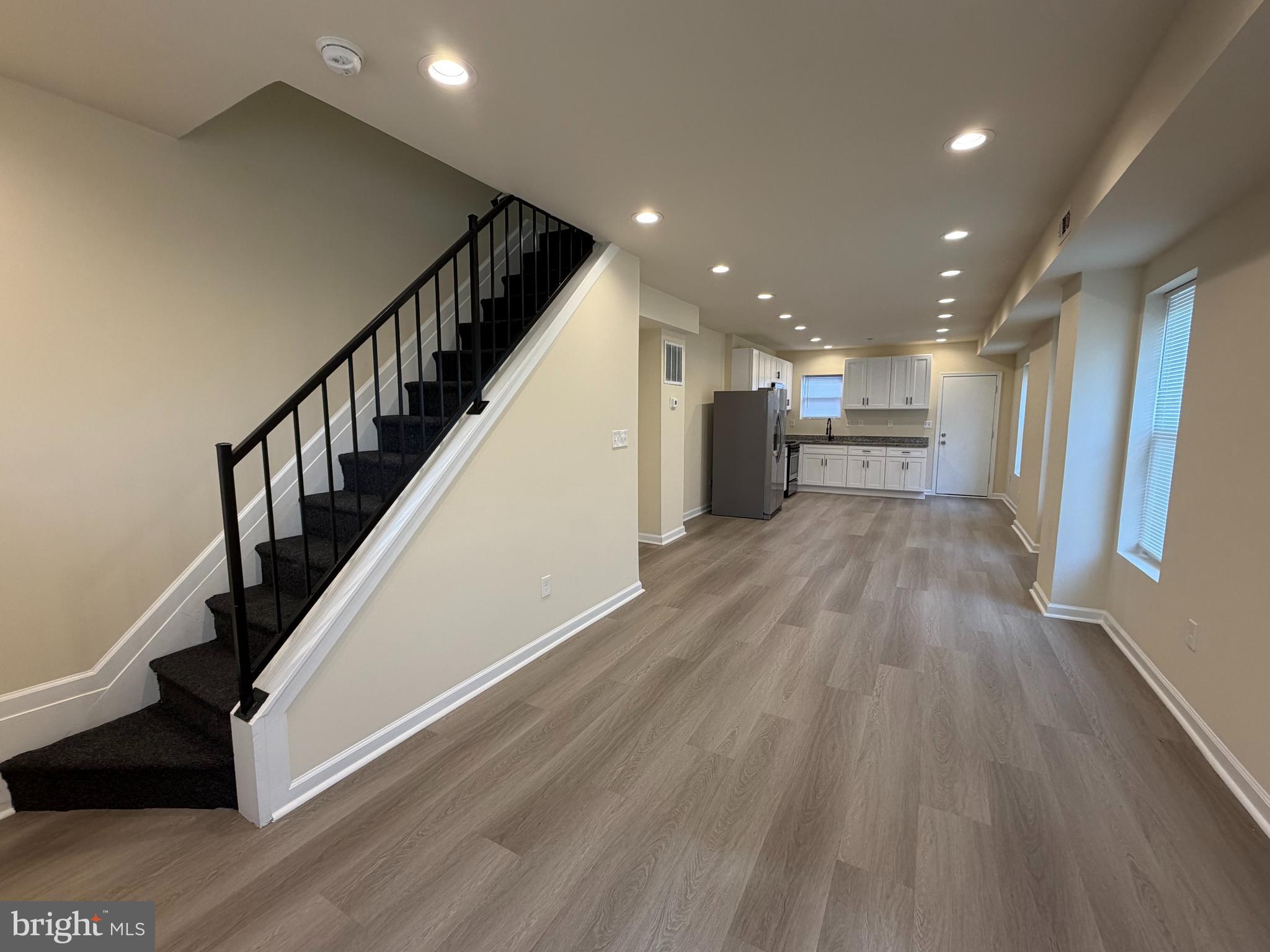 601 North Clinton Street Baltimore, MD 21205 - Photo 5 of 12 a view of a hallway with wooden floor and staircase