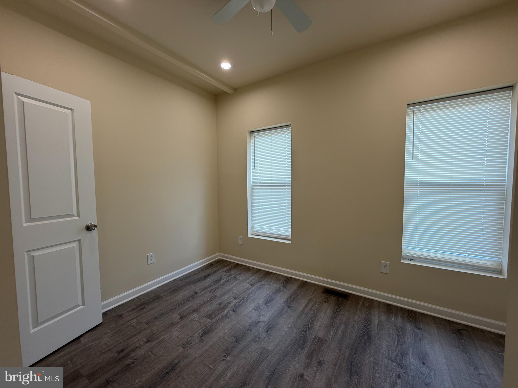 601 North Clinton Street Baltimore, MD 21205 - Photo 9 of 12 an empty room with wooden floor and windows