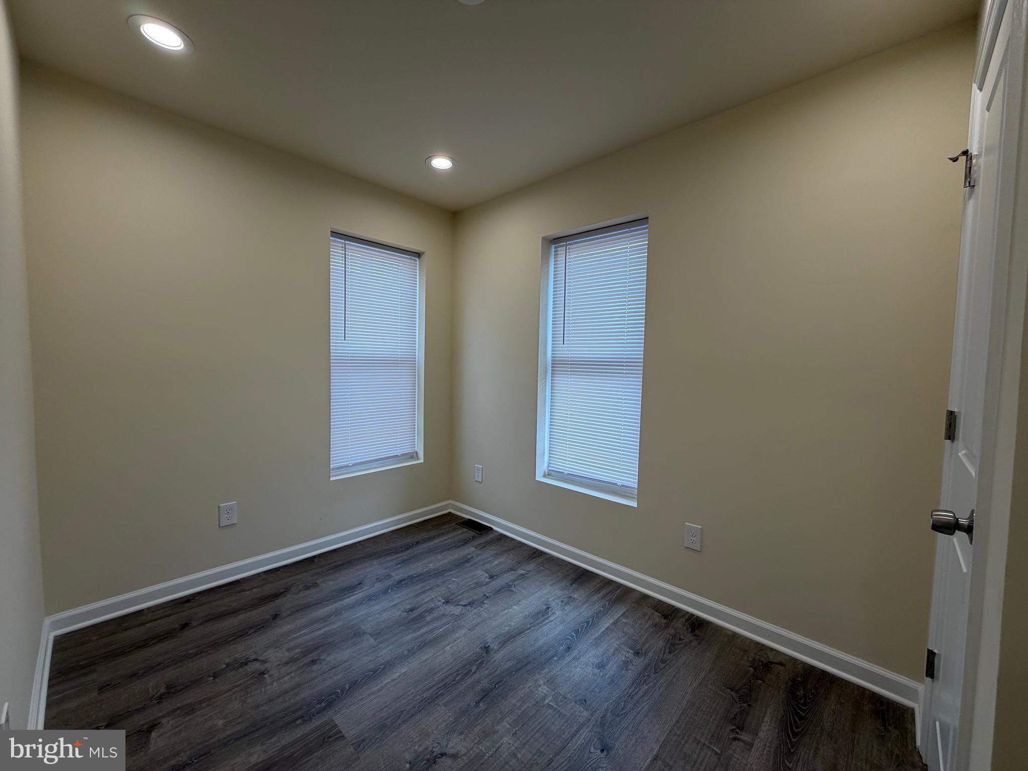 601 North Clinton Street Baltimore, MD 21205 - Photo 10 of 12 an empty room with wooden floor and windows