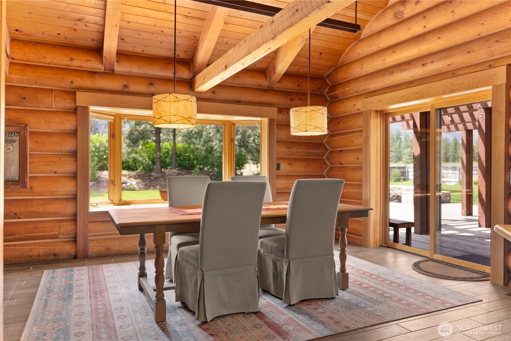 179 Wolf Creek Road Winthrop, WA 98862 - Photo 11 of 40 a view of a dining room with furniture wooden floor and a potted plant