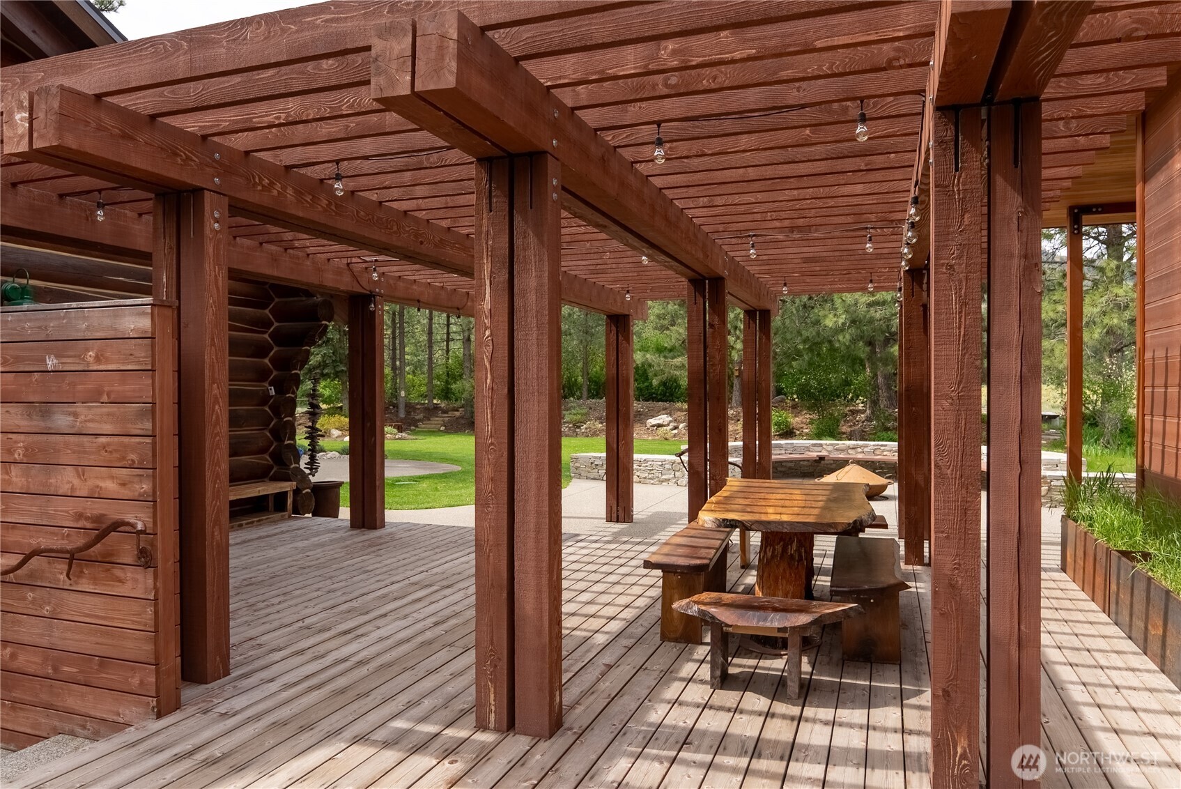179 Wolf Creek Road Winthrop, WA 98862 - Photo 13 of 40 a view of a patio with table and chairs and wooden floor