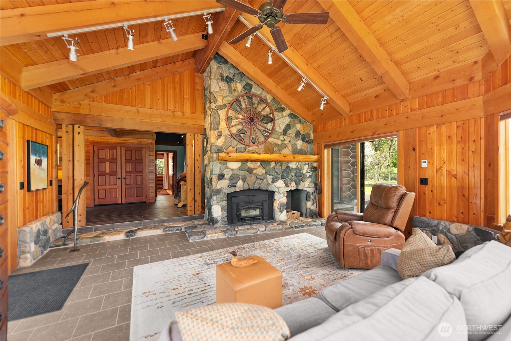 179 Wolf Creek Road Winthrop, WA 98862 - Photo 20 of 40 a living room with furniture a fireplace and a flat screen tv