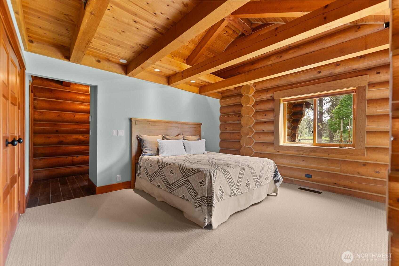 179 Wolf Creek Road Winthrop, WA 98862 - Photo 31 of 40 a spacious bedroom with a bed and a dresser